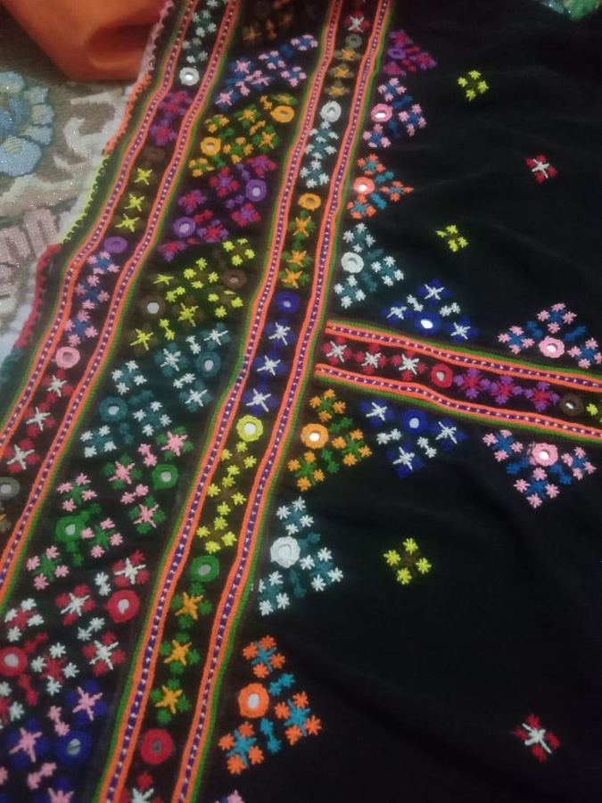 Black fabric with colourful mirror-work embroidery