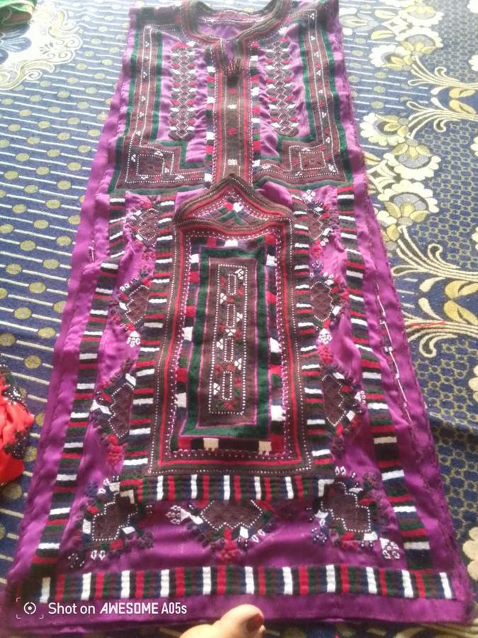 Magenta embroidered Balochi dress front laid flat