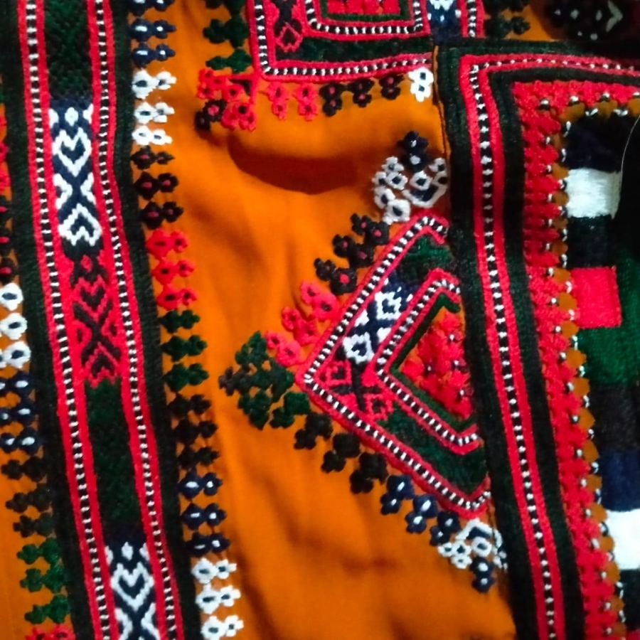Orange Balochi dress with red and green embroidery
