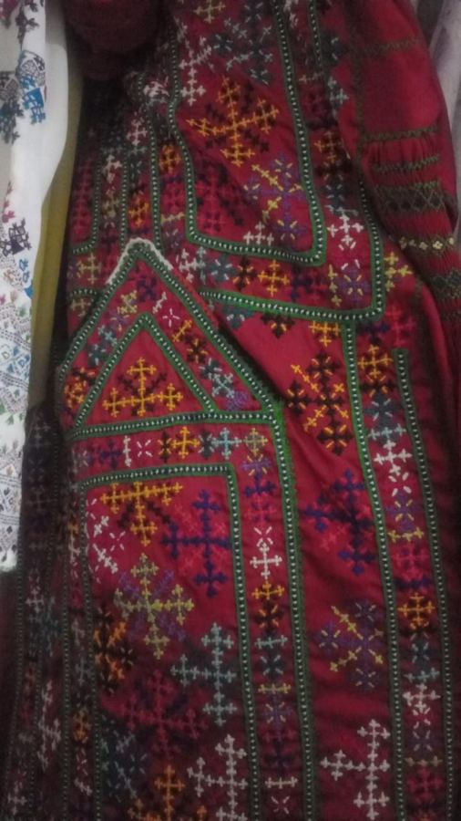 Red Balochi dress with colourful cross-stitch