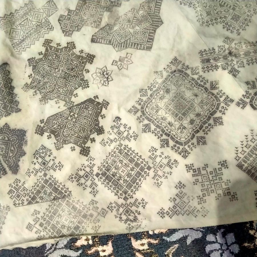 Traditional embroidery patterns printed on cream fabric